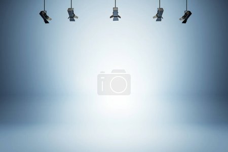 Modern studio setting with bright spotlights against a blue smooth gradient background. 3D Rendering