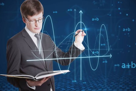 Attractive young european businessman with book using abstract glowing mathematical formula graph on blue background. Equation, digital data and mathematics app concept
