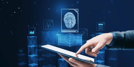 Close up of businessman hand pointing at tablet with abstract glowing fingerprint hologram on blurry blue background. Personal security concept