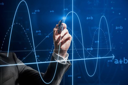 Close up of businessman hand with pen pointing at abstract glowing mathematical formula graph on blue background. Equation, digital data and mathematics app concept