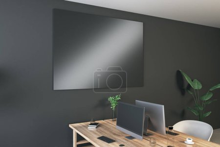 Contemporary coworking interior with empty black mock up screen on dark wall, desk, computer, chairs, decorative items, plants and supplies. Mock up, 3D Rendering