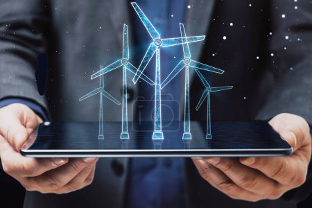 Photo for Close up of businessman hand holding tablet with glowing digital wind mill turbine hologram on blue background. Wind generator concept - Royalty Free Image