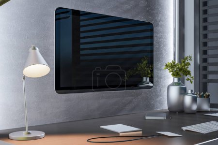 A modern computer monitor on a desk with a lamp, notepad, keyboard, and decorative plants on a concrete background, portraying a sleek workspace. 3D Rendering