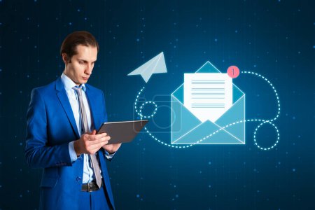 Electronic mail, sending and receiving, direct and online message concept with businessman using digital tablet checking his mailbox on dark background with envelope icon and notification alert