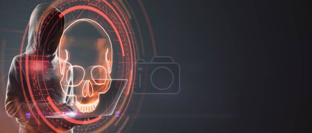 Hacker using laptop with digital red skull on wide dark background with mock up place. Ransomeware, virus and pirate threat concept. Double exposure