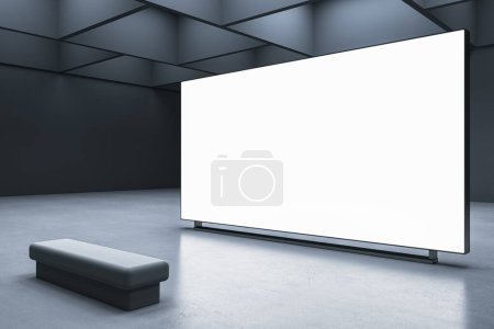 Foto de Perspectiva de la pantalla iluminada en blanco en blanco con espacio para su publicidad en el interior de la sala de exposiciones abstracta con fondo de pared oscura y banco en el suelo de hormigón. Representación 3D, maqueta - Imagen libre de derechos