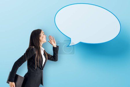 Photo for Attractive young european businesswoman with speech bubble on blue background. Opinion, speech and communication concept. Mock up place - Royalty Free Image