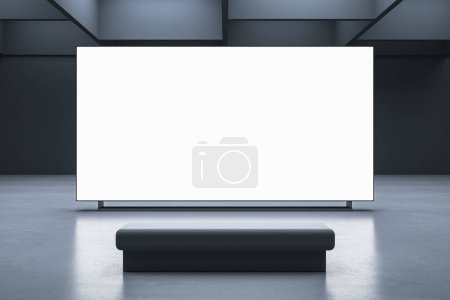 Foto de Vista frontal en blanco en blanco brillante pantalla con espacio para su texto publicitario o logotipo en el fondo de la pared oscura banco opuesto en el interior de la sala de presentación abstracta. Representación 3D, maqueta - Imagen libre de derechos