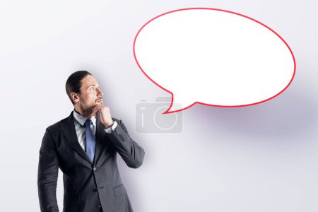 Photo for Attractive young european businessman with speech bubble on white background. Opinion, speech and communication concept. Mock up place - Royalty Free Image