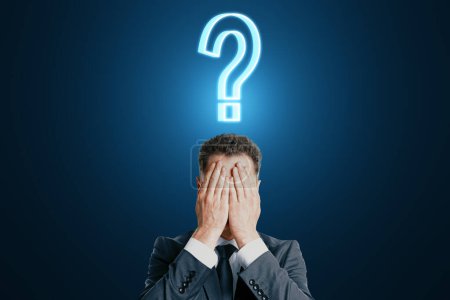 Photo for Facepalm man with question sign over his head, doubt and decision concept on dark blue background - Royalty Free Image