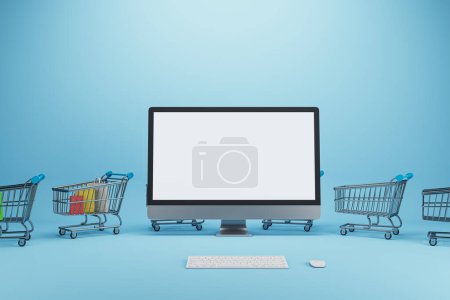 Creative online shopping concept with trolleys and empty white mock up computer screen on blue background. Shop online and digital media concept. 3D Rendering