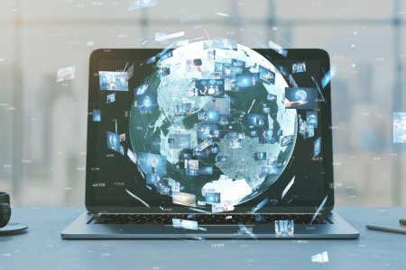 Close up of laptop with creative globe with telecommunication picture icons on blurry office workplace backdrop. Business, video conference, remote group work. Double exposure