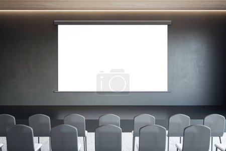 Front view on blank white poster with space for advertising text or logo on dark wall background opposite black chair rows in lecture hall, seminar or marketing concept. 3D rendering, mockup