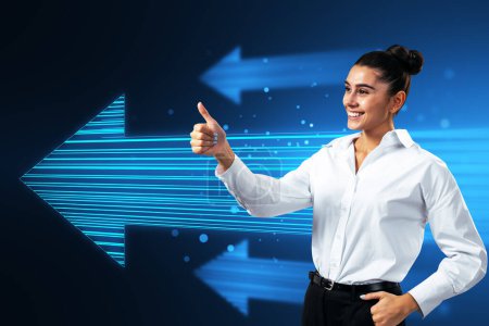 Photo for Side view of attractive happy european businesswoman showing thumbs up to glowing digital arrow made up of blue tech lines on dark background. Market, technology and top concept - Royalty Free Image