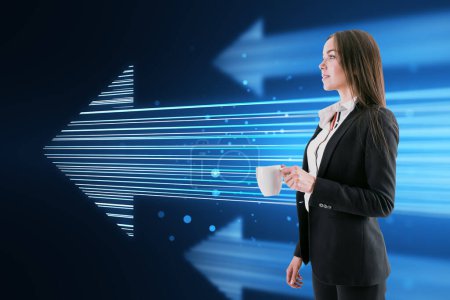 Photo for Side view of attractive young european businesswoman with coffee cup and glowing digital arrow made up of blue tech lines on dark background. Market, technology and top concept - Royalty Free Image