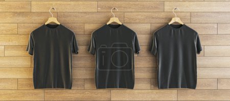 Téléchargez les photos : Three empty black t-shirts hanging on woooden wall background. Ad, textile and fashion concept. 3D Rendering - en image libre de droit