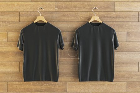 Téléchargez les photos : Two empty black t-shirts hanging on wooden wall background. Ad, textile and fashion concept. 3D Rendering - en image libre de droit