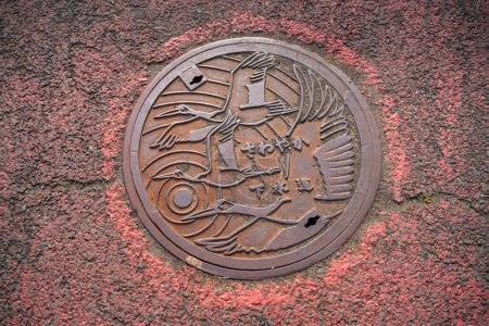 Photo for Kushiro, Hokkaido, Japan - August 15, 2023 - Scene of manhole cover engraved with crane as the symbol and attractive of Kushiro - Royalty Free Image