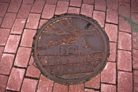Photo for Nemuro, Hokkaido, Japan - August 16, 2023 - Scene of manhole cover engraved with symbol and attractive of Nemuro - Royalty Free Image