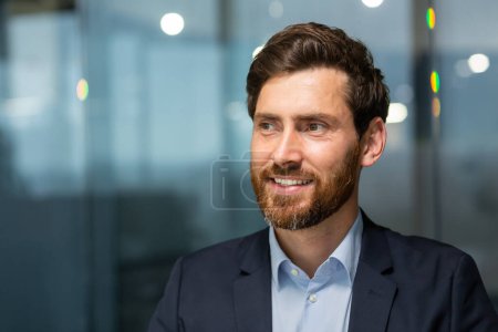 Photo for Close up photo of happy and smiling mature businessman inside modern office looking aside, man in business suit at work. - Royalty Free Image
