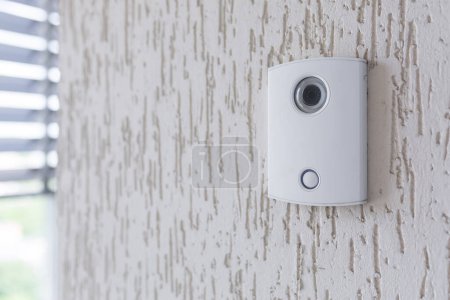 Photo for A white incoming electronic doorbell with a camera on the wall of the building, office. - Royalty Free Image