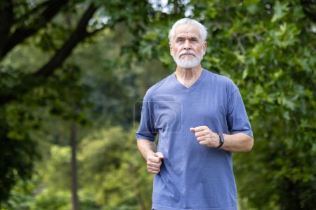 An active elderly man with a beard is jogging in a lush park, showcasing vitality and a commitment to fitness.
