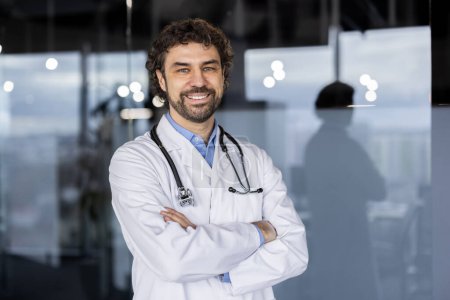 A welcoming Hispanic male doctor with a confident smile, standing in a modern hospital or clinic environment, exuding professionalism and warmth.