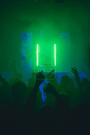 Photo for Silhouette of dj backlit while playing music in the fest - Royalty Free Image