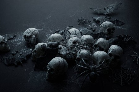 Photo for Creepy Halloween background - black bats and skulls on black - Royalty Free Image