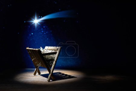 Nativity of Jesus, empty manger at night with bright lights