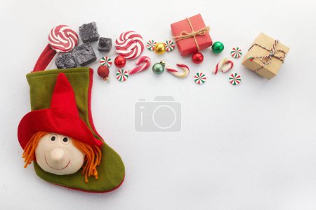 Befana sock with sweet coal and candy on white background. Italian Epiphany day tradition. High quality photo