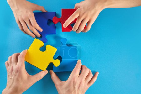 Photo for Father and autistic son hands holding jigsaw puzzle shape. Autism spectrum disorder family support concept. World Autism Awareness Day. - Royalty Free Image