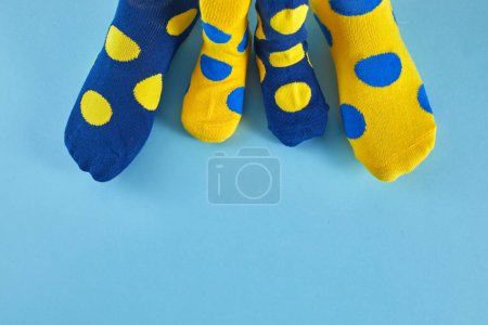 World Down syndrome day background. Down syndrome awareness concept. Legs with different socks as symbol of down syndrome.