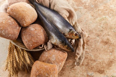 Photo for Catholic still life of five loaves of bread and two fish. - Royalty Free Image