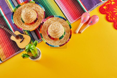 Cinco de Mayo holiday background. Maracas, cactus and hat on yellow background