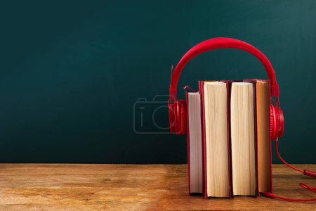 Foto de Concepto de libro de audio con pila de libros y auriculares - Imagen libre de derechos