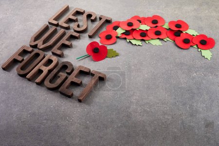 Photo for World War remembrance day. Red poppies on dark stone background. Lest we forget. - Royalty Free Image