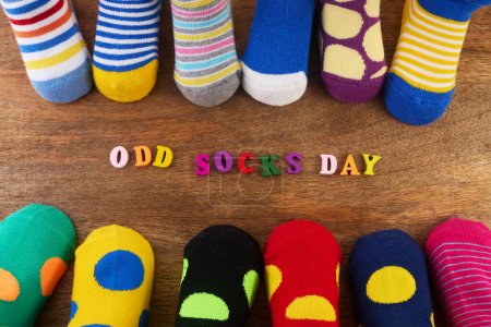 Photo for Odd Socks Day. Day lost socks, lonely socks on wooden background - Royalty Free Image