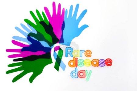 Photo for Rare Disease Day Background. Colorful hands and ribbon on white background. - Royalty Free Image