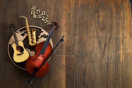 A variety of musical instruments arranged on a wooden background