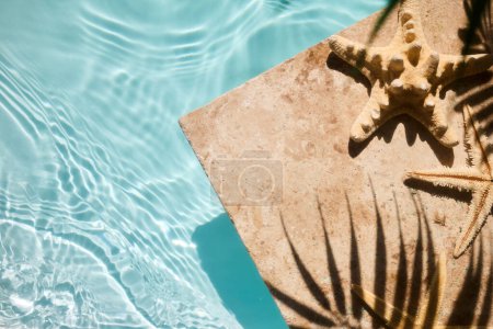 A serene poolside with starfish on sunlit tiles, capturing the essence of summer.