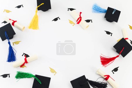 Photo for Top view of graduation caps, diplomas, and colorful balloons on white. - Royalty Free Image