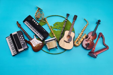 A variety of musical instruments laid out against a blue background.
