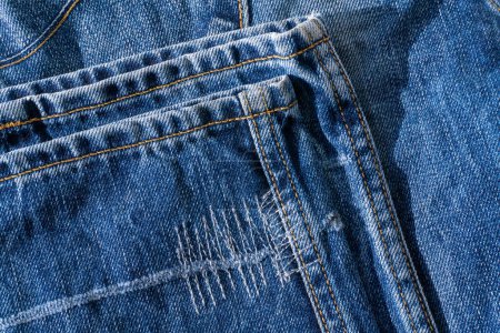 Photo for Details of blue jeans - hem with decorative seams background close up - Royalty Free Image