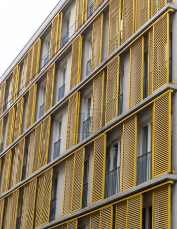 Windows of a building with yellow shutters in the old center of Budapest, Hungary