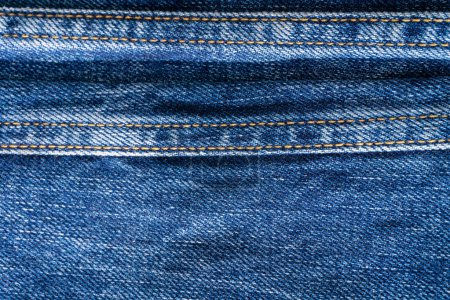 Photo for Blue denim with seams and light stains background close up - Royalty Free Image