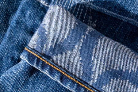 Photo for Blue jeans with patterns on the cuffs and decorative seams background close up - Royalty Free Image