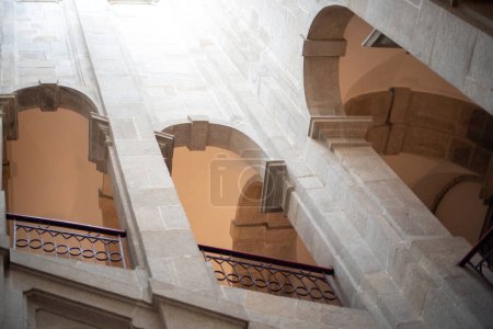 Interior of an ancient building with stairs, columns and arches. Portuguese Center of Photography