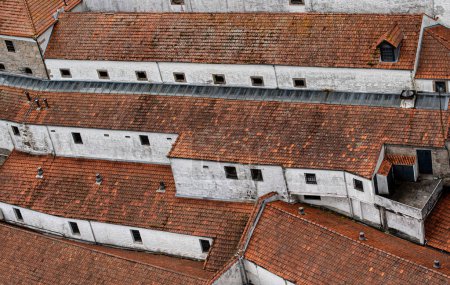 Photo for Background of old long white buildings with red tiled roofs. Portugal urban background - Royalty Free Image