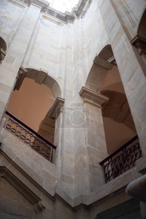 Interior of an ancient building with stairs, columns and arches. Portuguese Center of Photography